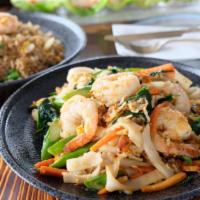 Pirada Noodle · Pan-fried big flat rice noodle with egg, shrimps, real crab meat, asparagus, baby spinach, c...