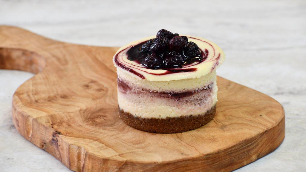 Beet & Berry Cheesecake · Our signature cheesecake — a creamy filling with delicious swirls of a fruit purée reduction made with roasted sweet beets, blueberries and red wine and topped with seasonal berry compote.