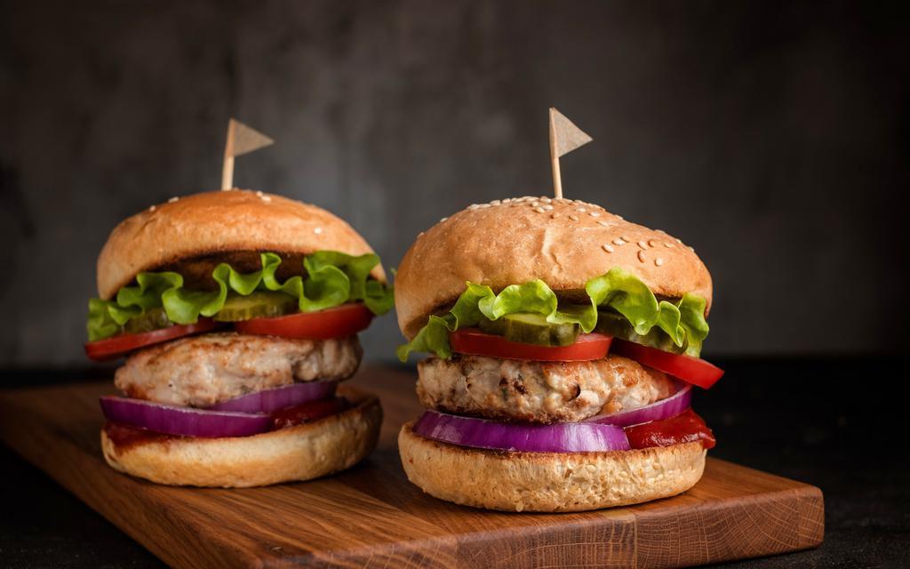Turkey Burger · 1/3 lb. seasoned ground white turkey breast with roasted red pepper mayo, lettuce, tomato, and onion on a bun.