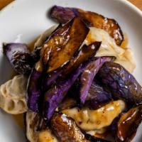 10. Pork Dumplings with eggplant · Buttery soft Chinese eggplant sauteed in soy garlic sauce served with steamed pork cabbage d...