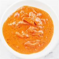 34. Butter Chicken · Tandoori boneless chicken cooked in rich creamy tomato sauce and onion gravy.