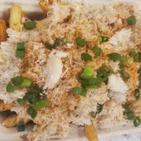 Cajun Crab Fries · Cajun fries layered with Old Bay garlic aioli, fresh pacific rock crab and a sprinkle of gre...