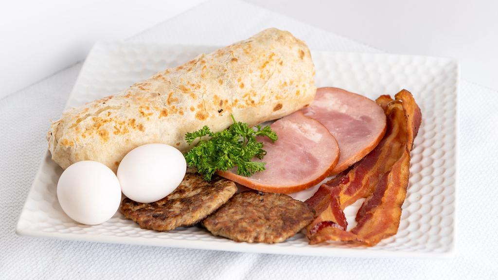 Breakfast Burrito · Serve with two  eggs scramble,choice of meats(Bacon, Ham, Sausage), Home fries potatoes, jack cheese, salsa.