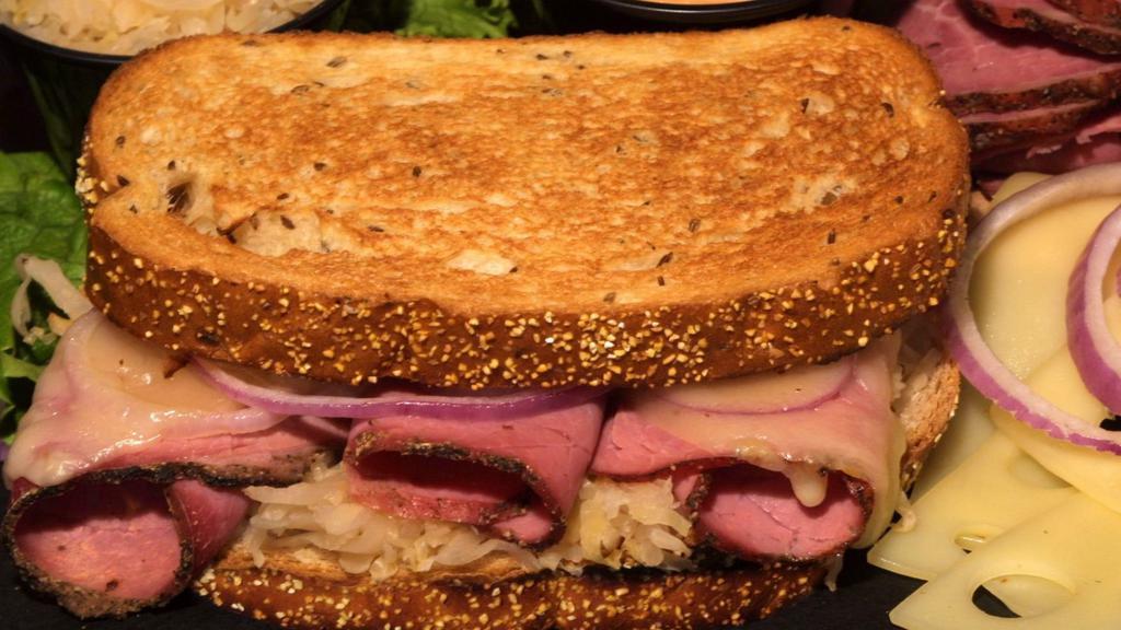 Reuben · Serve with sauerkraut, thousand island dressing, Swiss cheese and baked on rye bread. Your choice side salads.