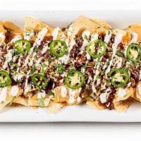 Boozy Chili Cheese Nachos · Chipotle beer cheese, house chili, aged cheddar, green onion crème, cilantro, pickled jalapeno