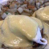 Eggs Benedict · Muffin, ham, poached eggs, hollandaise sauce with fruit or potatoes.