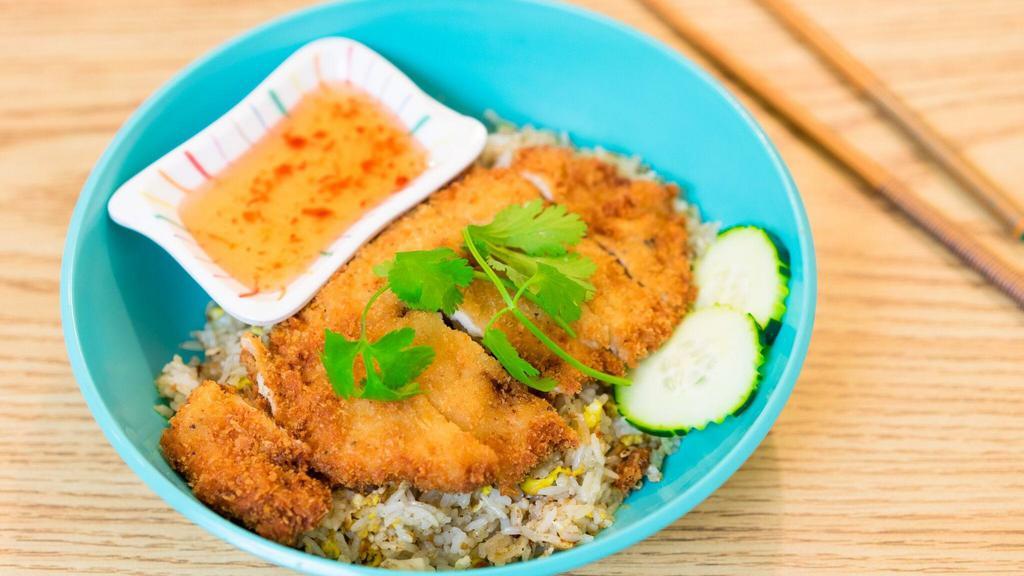 Fried Chicken Over Fried Rice · Egg fried rice top with deep fried marinated chicken come with sweet & sour sauce.