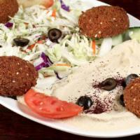 Falafel Plate · Four Crispy falafel served on a bed of cabbage, topped with hummus, tahini sauce and pita br...