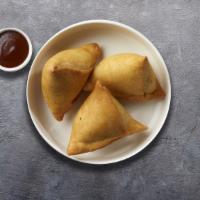 Seemingly Cocktail Samosa · Bite sized triangular shaped pastry filled with spicy green peas