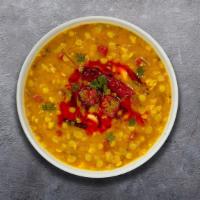 Dearly Dal Tadka · Split pea lentil cooked with garlic, tomato, mustards, and curry leaves.