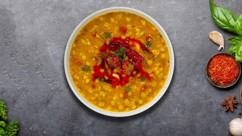 Mighty Masala Dal · Traditional Indian yellow lentil soup tempered with fried onion, tomato and special spices.