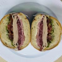 Cold Cut Trio Sandwich · Turkey, salami, and ham toasted on a French roll with provolone cheese, lettuce, tomato, oni...