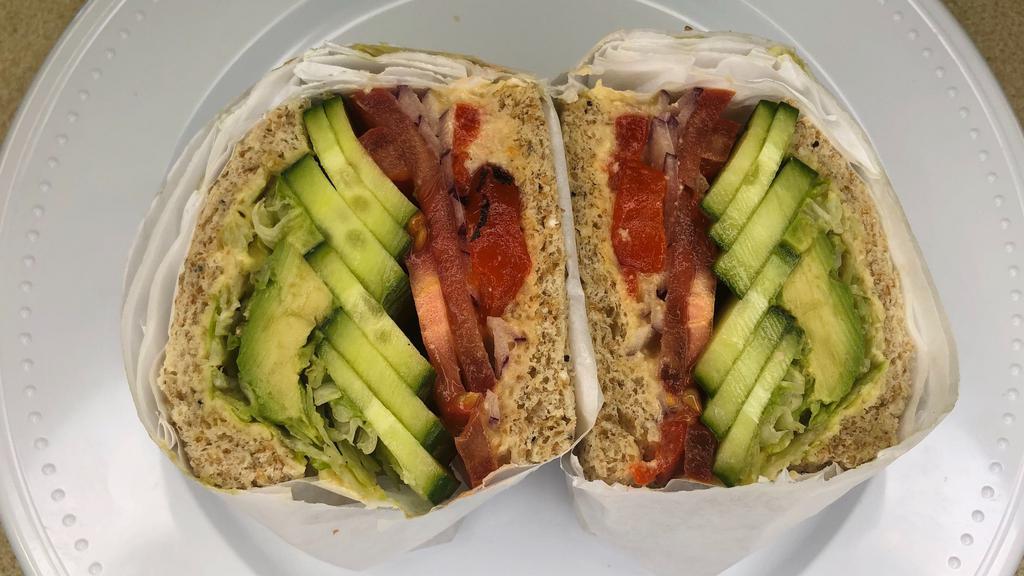 Vegan Veggie · Lettuce, tomato, onion, cucumber, roasted red bell peppers, avocado, and hummus toasted on a wheat roll.