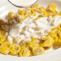 Tortellini cream · Tortellini filled with prosciutto, mortadella, parmigiano reggiano served in cream sauce and...