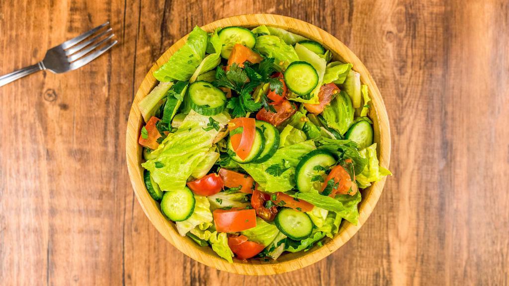 Margarita's Salad · Vegan, A fresh salad to enjoy any time. Cucumber, Tomatoes, lettuce, Cilantro, Parsley and Mint in a house dressing made with extra virgin olive oil and spices.