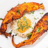 Tandoori Fish · Fillet of sol marinated with spices bakes over charcoal and served with some rice and sauce ...