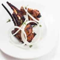 Lamb Chops · Tender pieces of lamb chops marinated in spices and baked over charcoal.