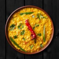 Tempered Golden Lentils · Yellow lentils, cooked to perfection over a slow flame and tempered with 'ghee' and spices.