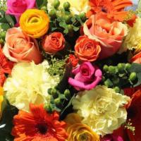 SK006. Brighten Your Day · Orange gerbera, yellow ranunculus, hot pink roses, peach roses, green berries, yellow carnat...