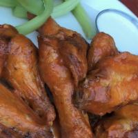 Wings · Available in traditional Buffalo style or Sticky Asian.  6, 12 or 18. (image shows 12 piece ...