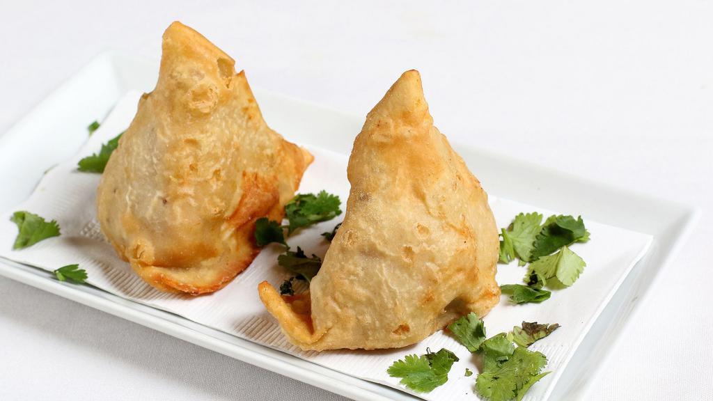 Vegetable Samosa (2 Pcs.) · Vegetarian. Crisp turnovers stuffed with mildly spiced potatoes and peas fried in vegetable oil.