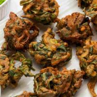 Palak Pakodi Chaat · Spinach fritters with predominant flavor of carom seeds, topped with sweet and sour tamarind...