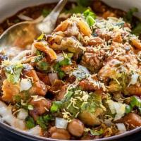 Samosa Chaat · Crunchy samosa served with chickpea, yoghurt, tamarind and mint sauces