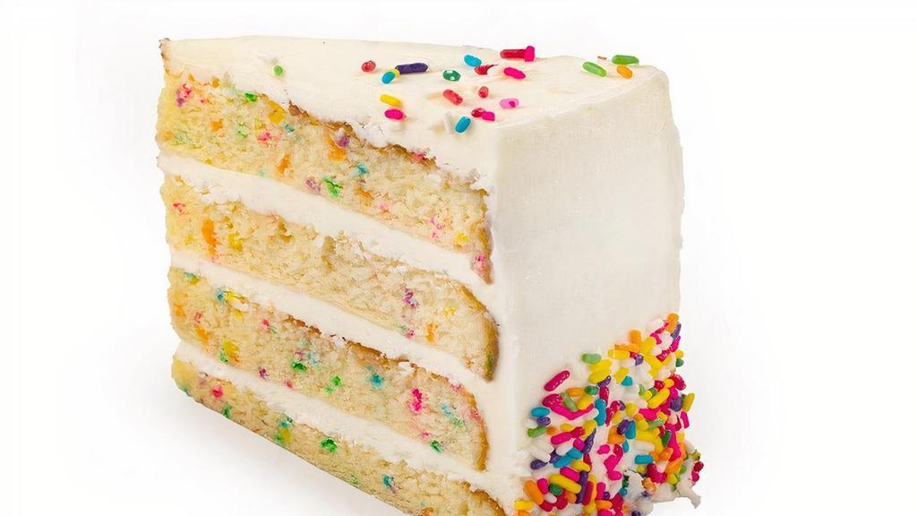 Confetti Cake Slice · Vanilla cake with rainbow sprinkles baked in, filled & iced with velvety vanilla buttercream confetti icing & rainbow sprinkles