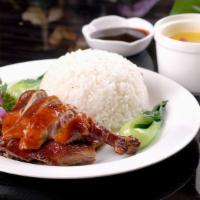 Roasted Duck Rice Place 明炉烧鸭饭 · Mr. Duck is holding the rice.
