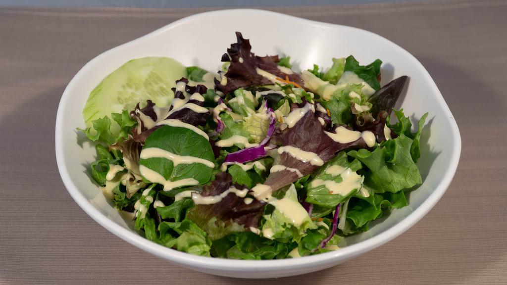 House Salad · Freshly mixed greens with sesame dressing.