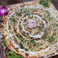 Pizzadilla · A 12 inch round quesadilla with your choice of meat & garnished with Cilantro, Onion, Sourcr...