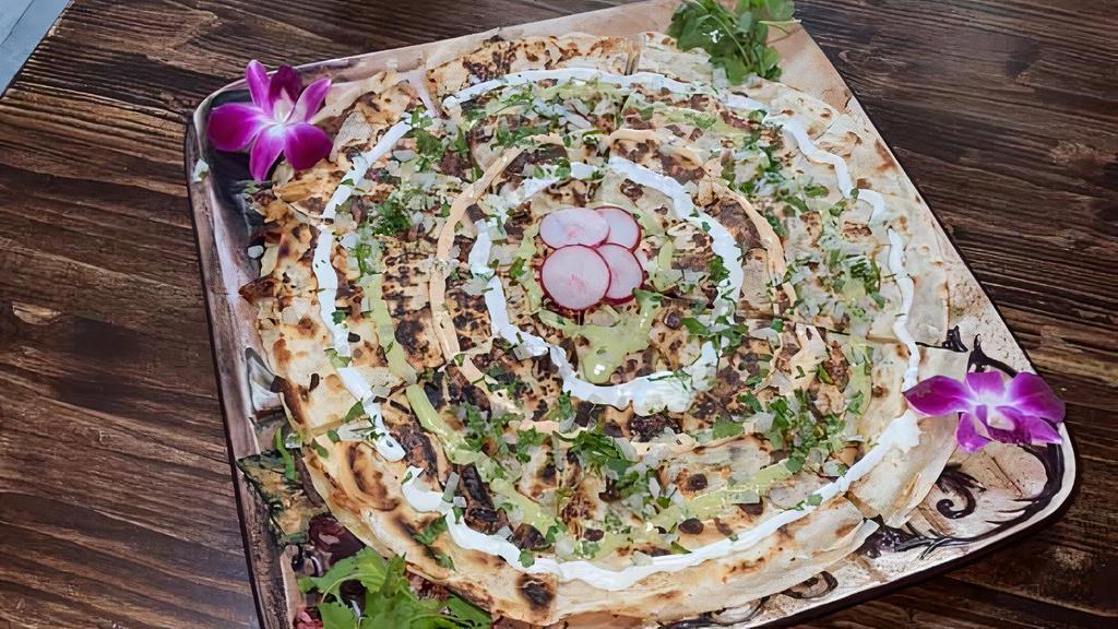 Pizzadilla · A 12 inch round quesadilla with your choice of meat & garnished with Cilantro, Onion, Sourcream and our homemade salsas.