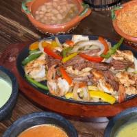 Fajitas Cielo, Mar, Y Tierra · w/ rice & beans. Chicken, Shrimp, and Beef fajitas