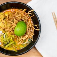Khao Soi Gai · Northern Thai-style curry, egg noodle, chicken, pickled mustard, shallot, cilantro, fried gr...