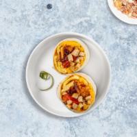 Meaty Chicken Breakfast Burrito · Two scrambled eggs, chicken sausage, breakfast potatoes, and melted cheese wrapped in a fres...
