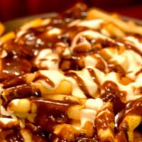 Poutine · Russet Potato French Fries With White Cheddar Cheese Curds, Mornay Sauce, And Porcini Gravy.