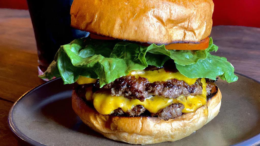 Double Pattie Smash Burger · Pasture raised, organic smash burger. Two patties between a brioche bun and smothered in caramelized onions with American cheese. Add bacon, extra pattie for an additional charge.