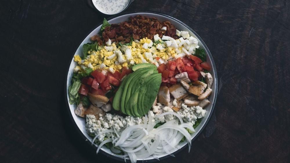 Cobb Salad · Chopped Romaine & Butter Lettuce, Grilled Chicken, Bacon, Hard Boiled Egg, Onions, Tomato, Bleu Cheese Crumbles & Avocado.
Bleu Cheese Dressing On Side.