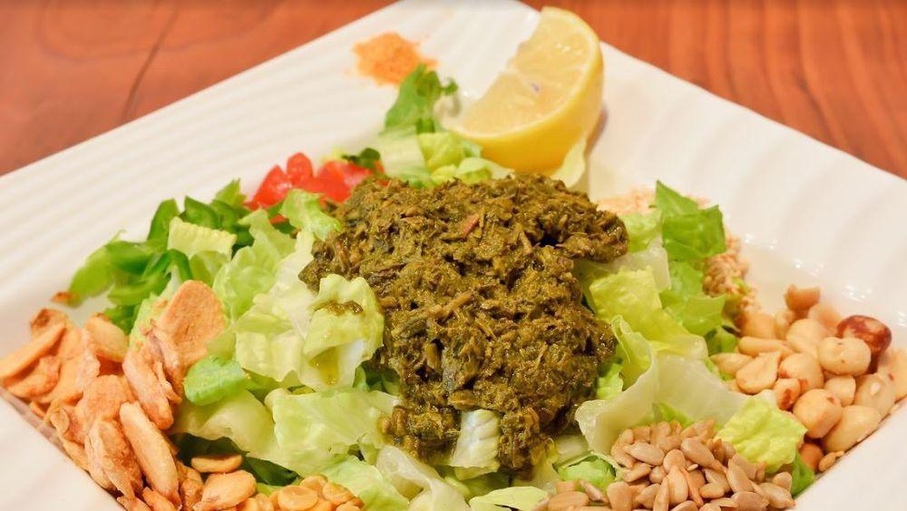 Tea Leaf Salad & Rice · Traditionally prepared Burmese food, salad mixed with cabbage, fried garlic, yellow split peas, peanuts, sesame seeds, sunflower seeds, tomatoes, jalapeños, lemon, served with a choice of rice. Indicate that this item can be made gluten free.