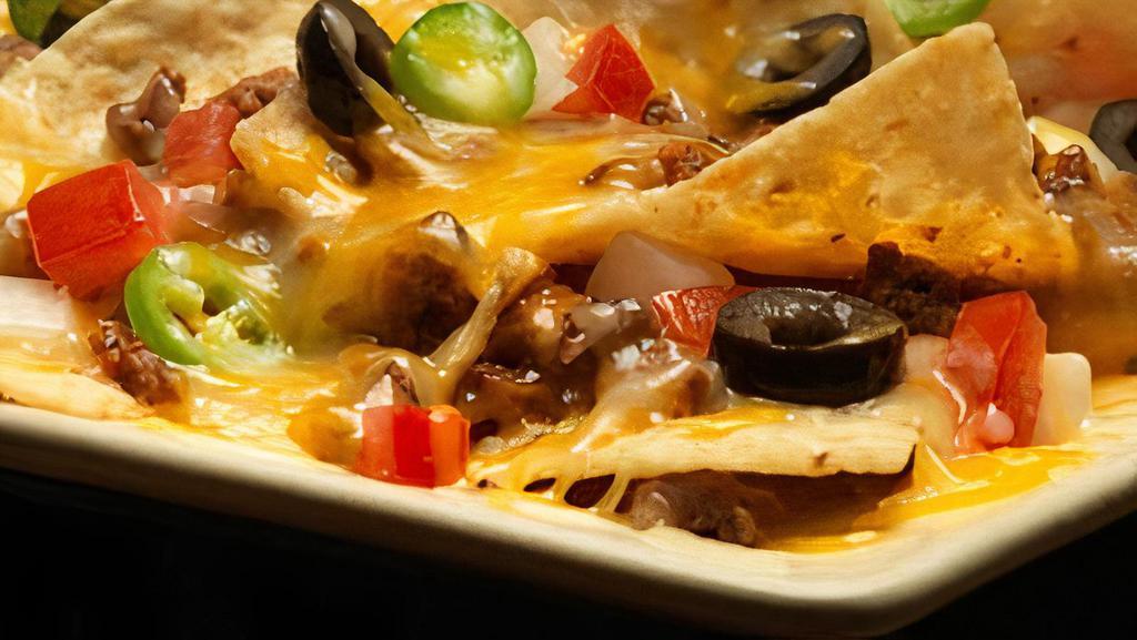 Nachos · Chips, cheese, beans, guacamole, sour cream, lettuce, and grilled onions. Served with choice of protein.