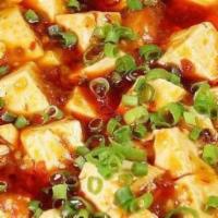 Szechwan Tofu · Classic soft tofu simmering in Szechwan chili sauce .