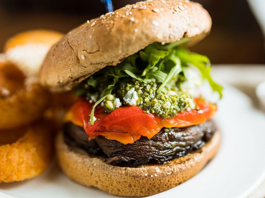 Grilled Portobello Cap · Roasted bell peppers, crumbled blue cheese, arugula, pesto sauce and wheat bun.