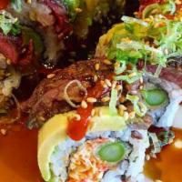 07. Cowboy Roll · Spicy crabmeat, tempura asparagus topped with grilled ribeye steak, avocado, and house speci...