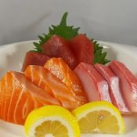 15. Nine Pieces Sashimi · Three pieces salmon, three pieces hamachi and three pieces tuna.
