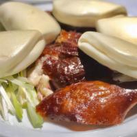 Peking Duck Half · Crispy skin & tender duck meat served with Chinese bun, and scallion slices.