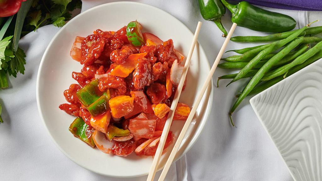 Sweet & Sour Pork · Pork with bell peppers, onions, carrots & pineapples in sweet and sour sauce.