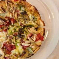 John Dillinger Pizza · Pesto sauce, slivered almonds, roasted red bell peppers, roasted garlic, and romano cheese.