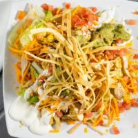 Chicken & Guacamole Salad · Cheddar cheese, chopped tomatoes, sour cream, guacamole, grilled chicken and tortilla strips...
