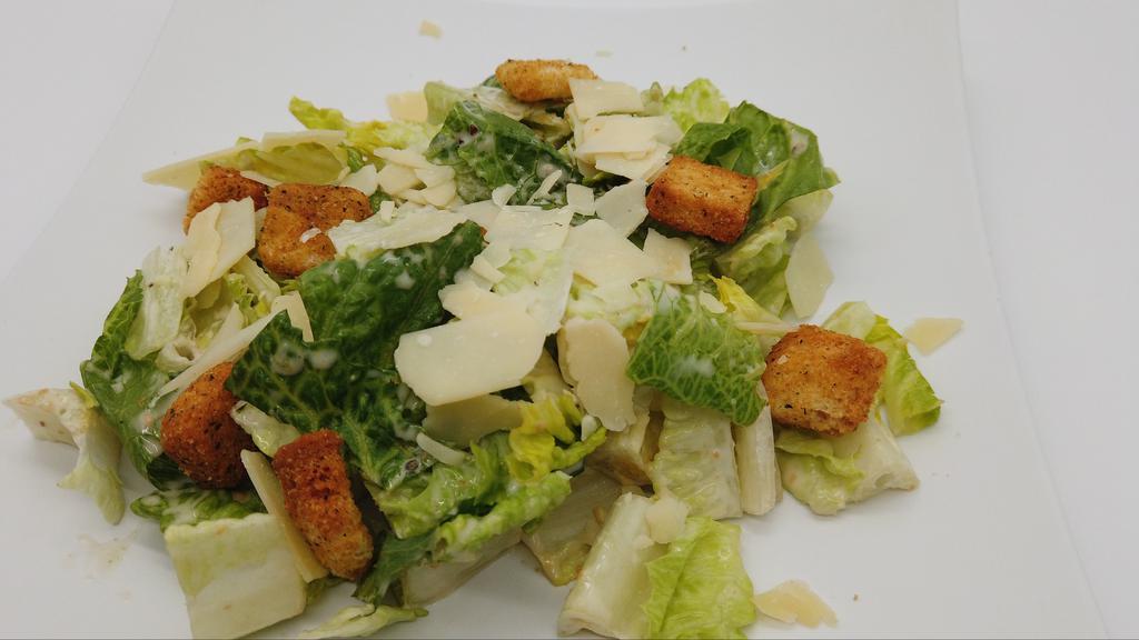 Traditional Caesar Salad · Chopped romaine hearts, garlic croutons, shaved Parmesan cheese, and caesar dressing.