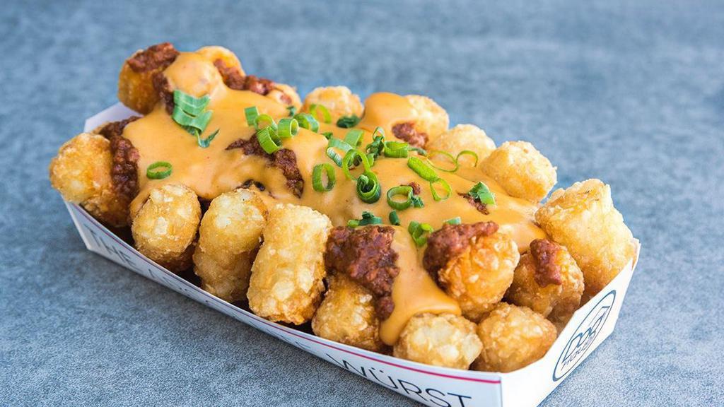 CHILI CHEESE TOTS · tots, cheddar cheese sauce, haus chili, green onions